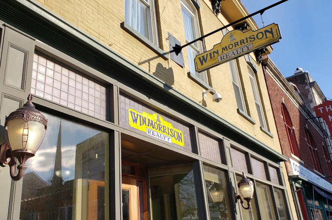 Win Morrison Realty’s Kingston office storefront with its hanging sign